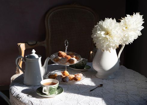 tea break in english style, vintage retro still life, homemade buns and a bouquet of white dalias. High quality photo