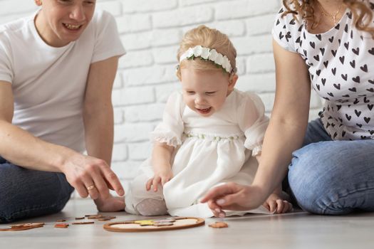 Child girl with cochlear implant plays at home. Hear impairment and diversity and hearing aid