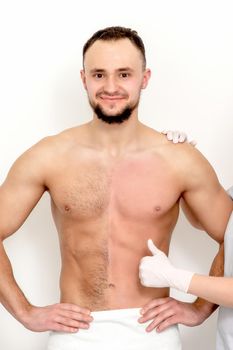 Young caucasian man with bare chested before and after waxing his hair with thumb up of hand of beautician standing on white background