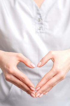Close up of female hands making heart shape. Romantic concept.