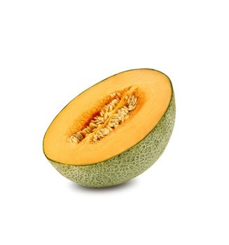 Half of yummy, ripe cantaloupe melon in a cross-section, isolated on white background with copy space for text or images. Sweet orange flesh with seeds. Pumpkin plant family. Side view. Close-up shot.