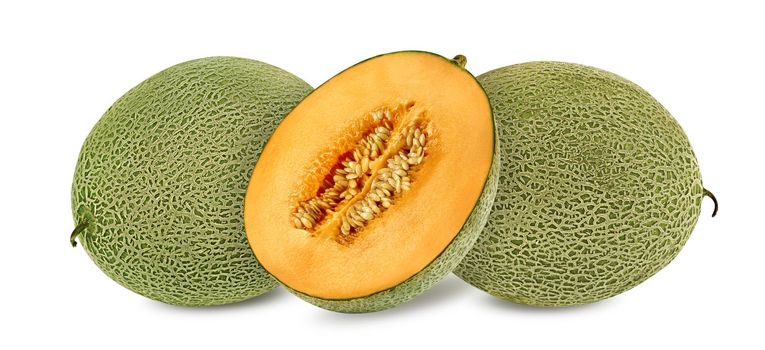 Two yummy cantaloupe melons and a half in a cross-section, isolated on white background with copy space for text or images. Mellow orange color pulp with seeds. Pumpkin plant family. Side view. Close-up shot.