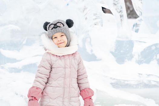 portrait of a cute baby girl in a snowy town on a winter day