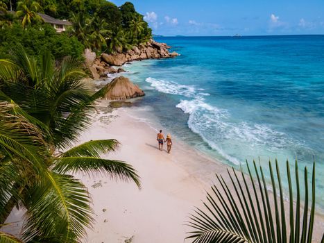 Anse Patates beach, La Digue Island, Seyshelles, Drone aerial view of La Digue Seychelles bird eye view.of tropical Island. mature couple men and women on vacation in Seychelles