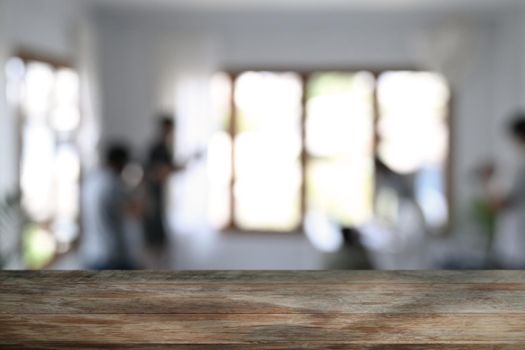 Wooden table in front of blurred background of restaurant. Copy space for advertising text or montage your products.