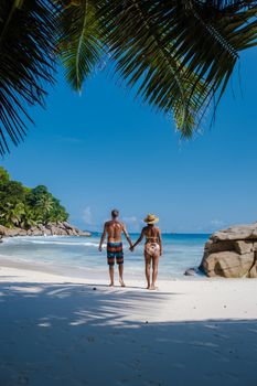 Anse Patates beach, La Digue Island, Seyshelles, Drone aerial view of La Digue Seychelles bird eye view.of tropical Island. mature couple men and women on vacation in Seychelles