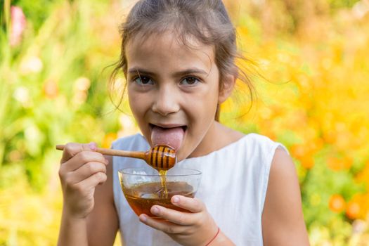 The child eats flower honey. Selective focus. Nature.