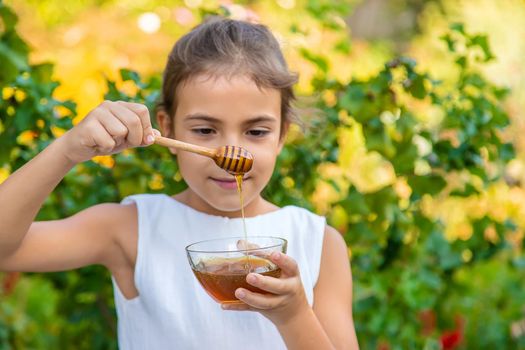 The child eats flower honey. Selective focus. Nature.