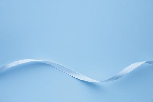 Background for a greeting card. Blue ribbon on a paper background. High quality photo