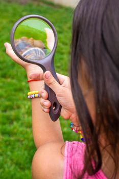 The child examines the snails on the tree. Selective focus. Nature.