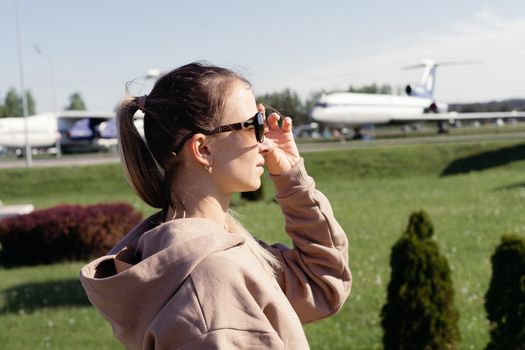 close-up. young woman standing looking at the planes.