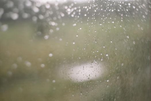 Natural pattern of rain drops on window glass surface