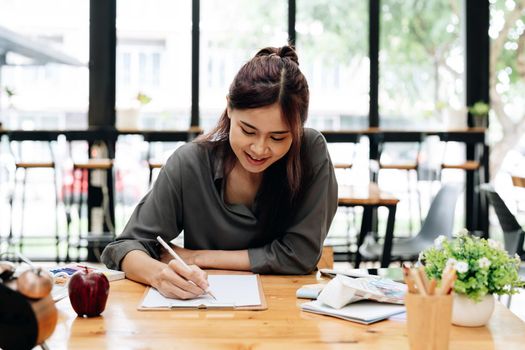 Pretty smiling young woman drawing a picture. Smiling young woman draw a picture at studio.