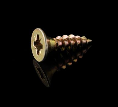 Wood screw yellow on a black background with reflection