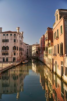 Venice, Italy - 10.12.2021: Traditional canal street with gondolas and boats in Venice, Italy. High quality photo