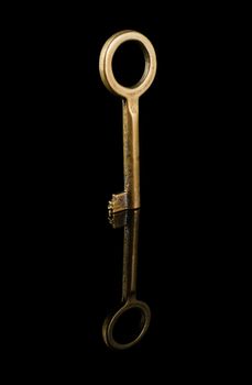 Old key, close up, on a black background isolated, with reflection