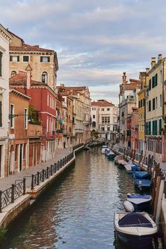 Venice, Italy - 10.12.2021: Traditional canal street with gondolas and boats in Venice, Italy. High quality photo