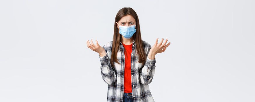 Coronavirus outbreak, leisure on quarantine, social distancing and emotions concept. Wtf happening. Confused and distressed young woman asking for answers, shrugging dismay frowning upset.