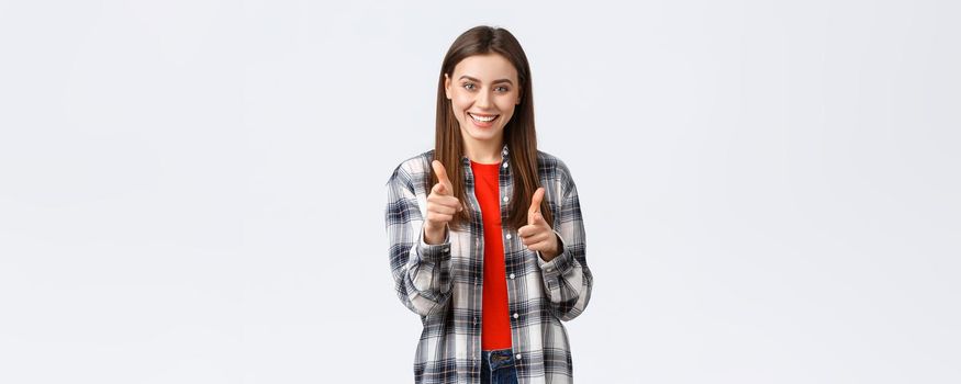 Lifestyle, different emotions, leisure activities concept. Enthusiastic and happy young pretty girl in casual outfit pointing fingers at camera, gotcha or congratulations gesture, choosing you.