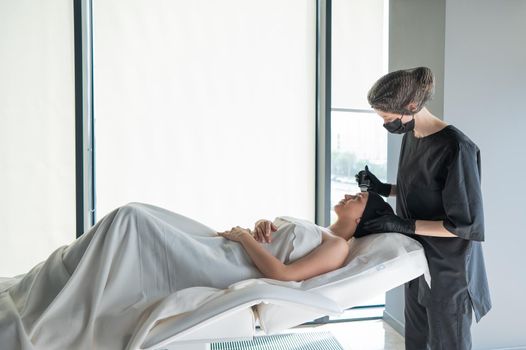 Woman on ultrasonic cleaning procedure. Hardware cosmetology