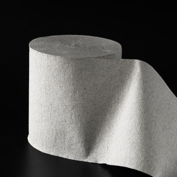 Roll of toilet paper, on black background isolated