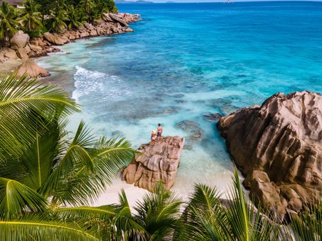 Anse Patates beach, La Digue Island, Seyshelles, Drone aerial view of La Digue Seychelles bird eye view.of tropical Island. mature couple men and women on vacation in Seychelles