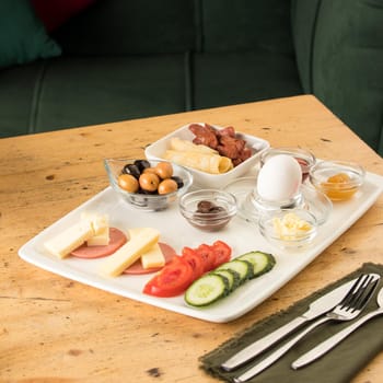 A closeup shot of a breakfast white plate on a wooden table