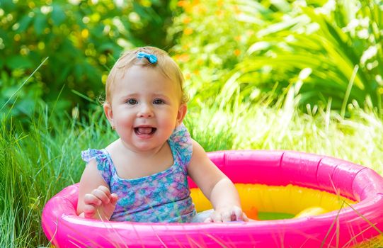 Baby swims in the pool. Selective focus. Child.