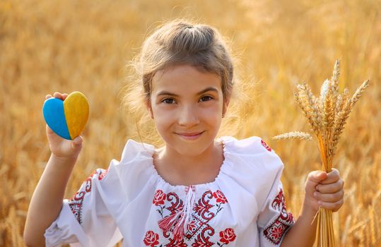 Child in a wheat field. In vyshyvanka, the concept of the Independence Day of Ukraine. Selective focus. Kid.