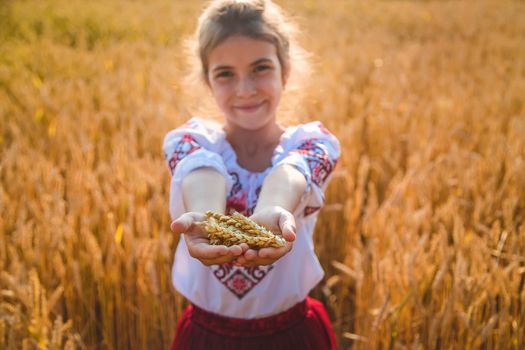 Child in a wheat field. In vyshyvanka, the concept of the Independence Day of Ukraine. Selective focus. Kid.