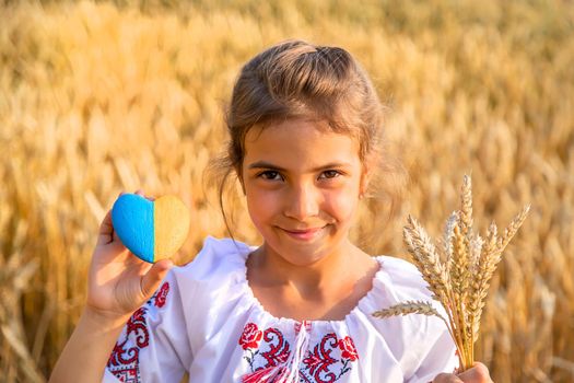 Child in a wheat field. In vyshyvanka, the concept of the Independence Day of Ukraine. Selective focus. Kid.
