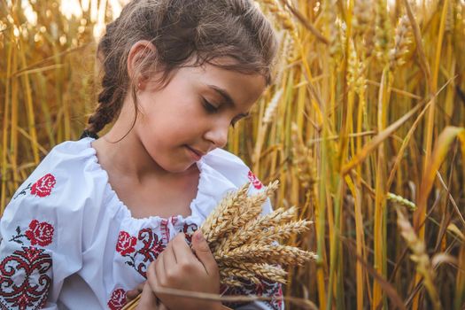 Child in a wheat field. In vyshyvanka, the concept of the Independence Day of Ukraine. Selective focus. Kid.