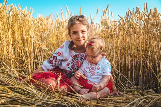 Child in a wheat field. In vyshyvanka, the concept of the Independence Day of Ukraine. Selective focus. Kid.