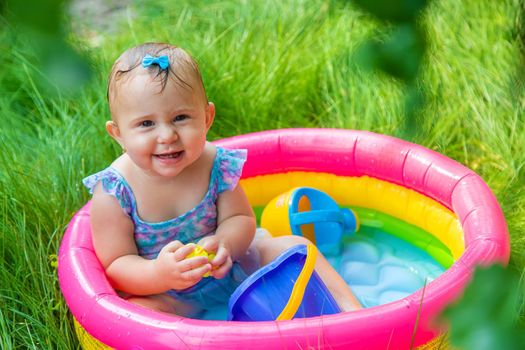 Baby swims in the pool. Selective focus. Child.