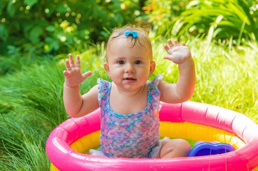 Baby swims in the pool. Selective focus. Child.