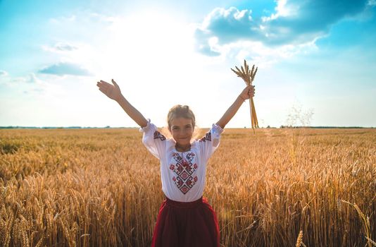 Child in a wheat field. In vyshyvanka, the concept of the Independence Day of Ukraine. Selective focus. Kid.