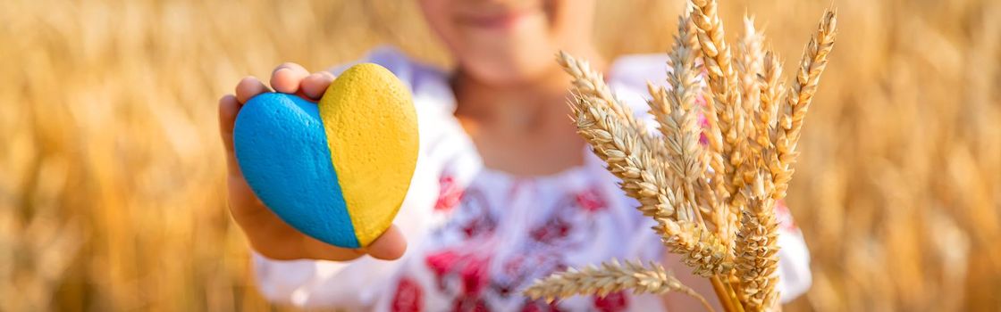 Child in a wheat field. In vyshyvanka, the concept of the Independence Day of Ukraine. Selective focus. Kid.