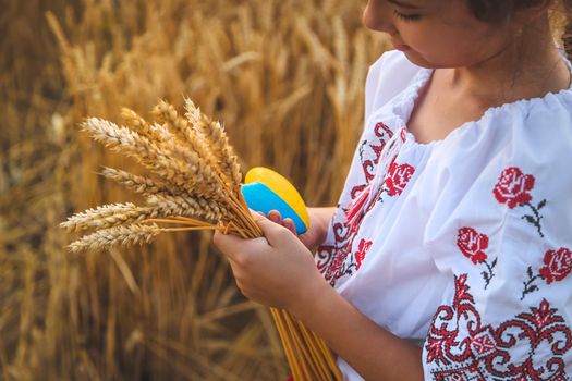 Child in a wheat field. In vyshyvanka, the concept of the Independence Day of Ukraine. Selective focus. Kid.