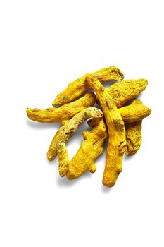 Dry Turmeric roots or barks isolated on white background. Top view. Still life. Copy space. Flat lay