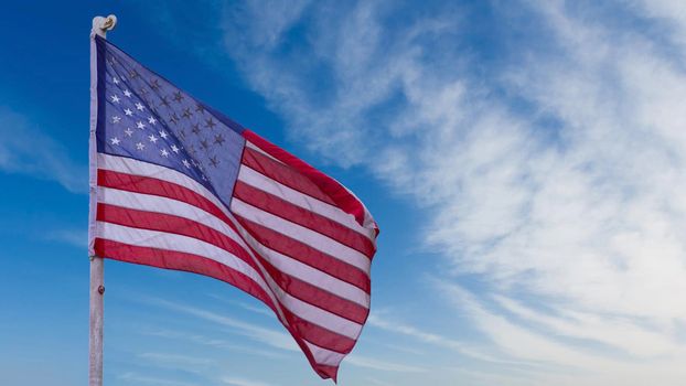 illustration of American Flag waving in sky backdrop