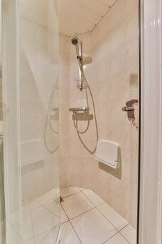 Ordinary shower cabinet with simple silver colored appliances