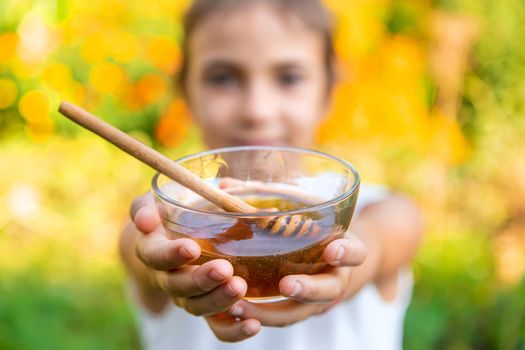 The child eats flower honey. Selective focus. Nature.