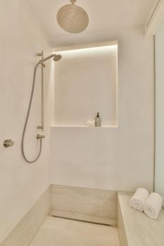 Interior of contemporary bathroom with shower, bathtub and sink in minimal style in flat