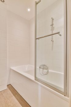 White bathtub with metal faucet in modern bathroom in minimal style in apartment