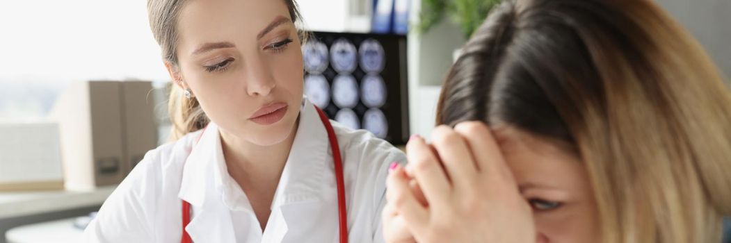 Portrait of upset woman client got her diagnostic results and cry while doctor writing prescription. Planned checkup in private clinic. Medicine concept