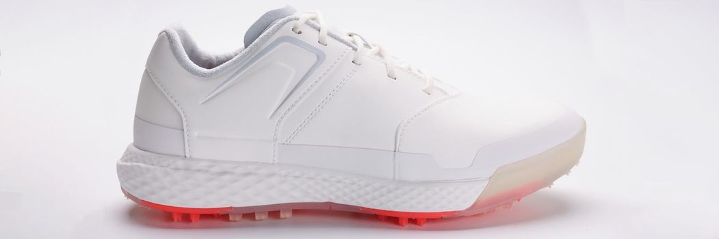 Close-up of stylish white sport shoe with bright neon sole model for running. Trendy footwear for every day. Fashion, design, photoshot promotion concept