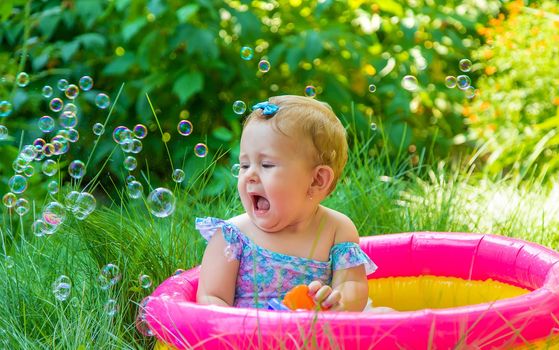 Baby swims in the pool. Selective focus. Child.