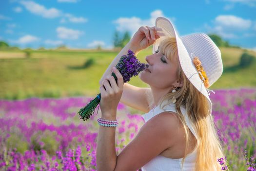 Woman with hat in lavender field. Selective focus. Nature.