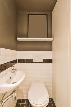 Stylish cozy rest room with white and black appliances