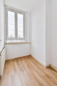 Plastic window and radiator on white wall in empty light room at home